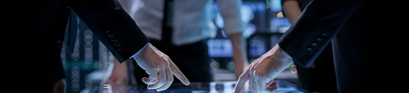 Itology365 consultants reviewing systems on a touchscreen table